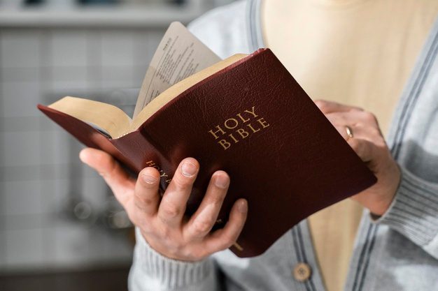 front-view-man-holding-bible_23-2148822691